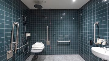 A bathroom with a shower, toilet, and sink.