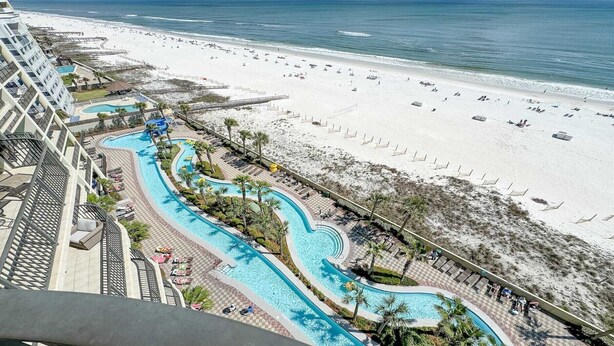 A resort with a large pool area, a beach, and a view of the ocean. - New to the Rental Market, Newly Owner, Newly Renovated!!! (Orange Beach)