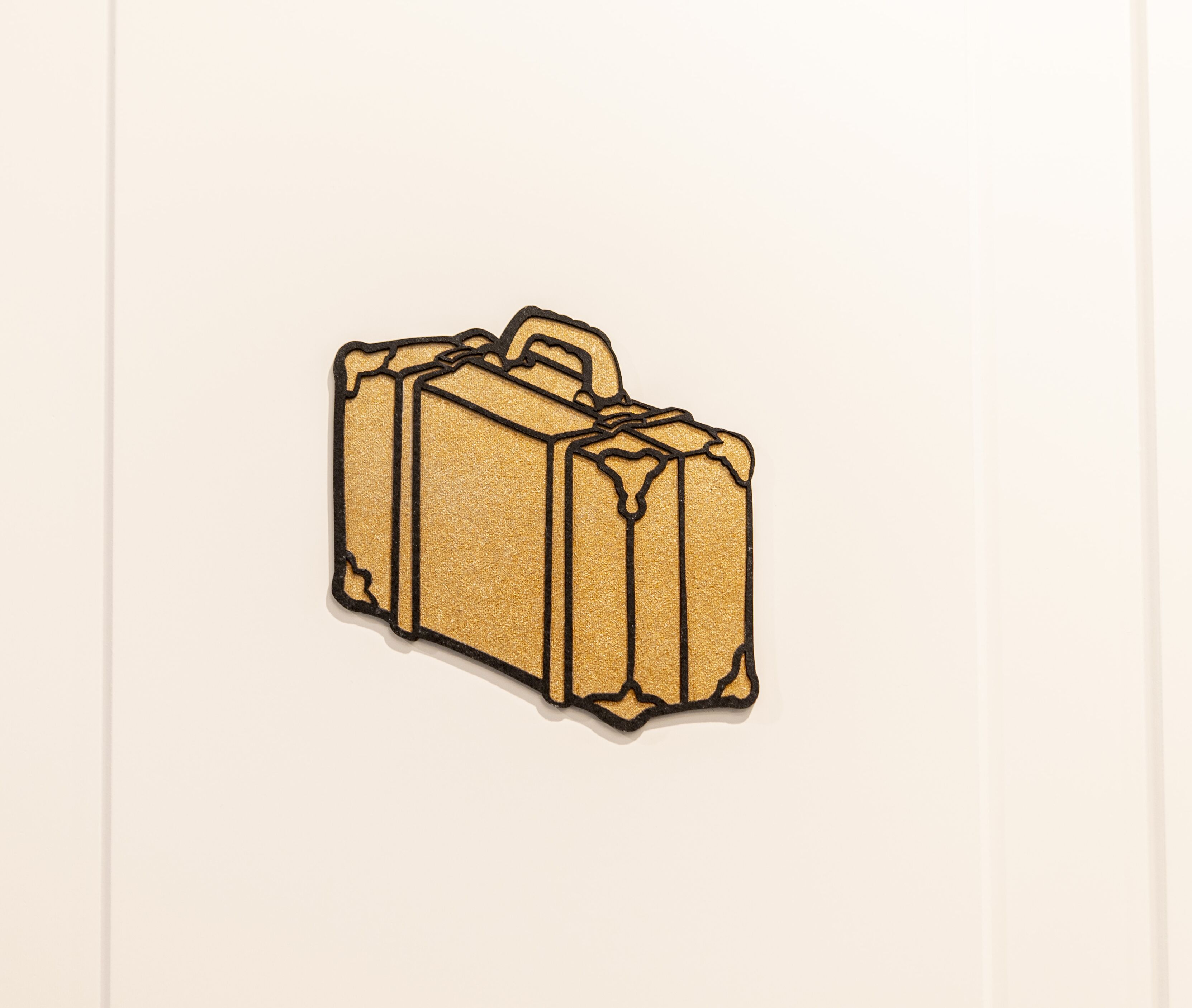 A suitcase with a handle and a textured surface.