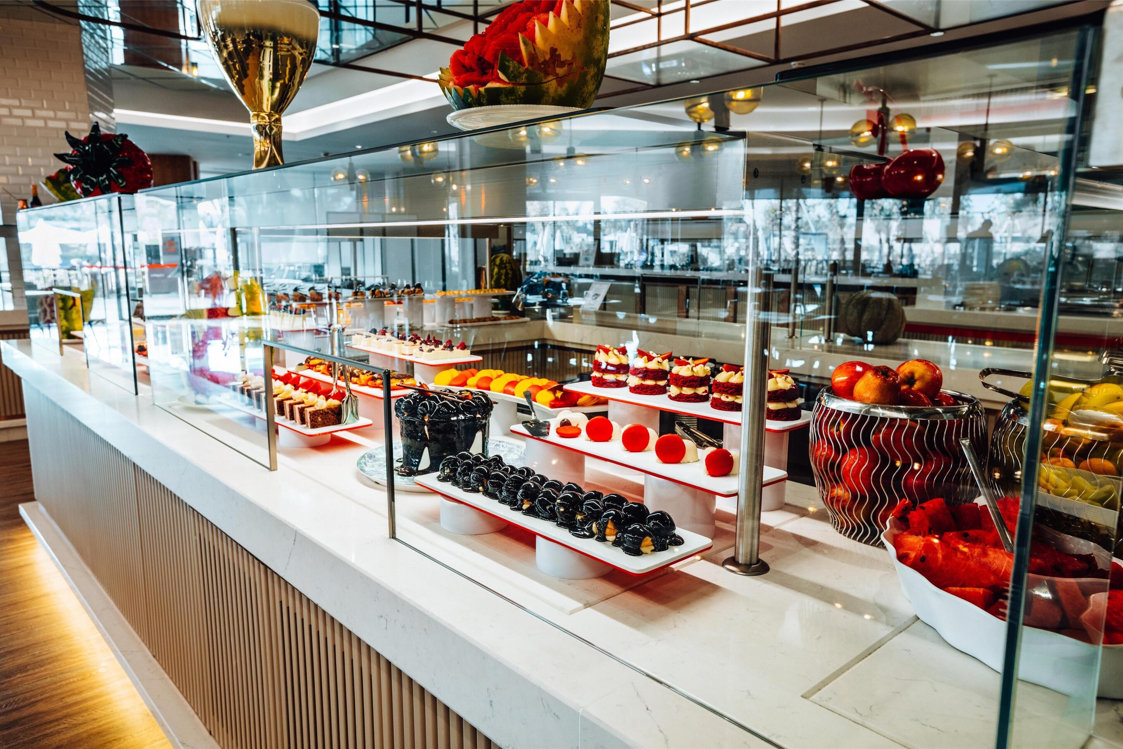 A bakery display with various pastries and desserts.