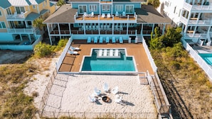Un complexe hôtelier doté d’une piscine, de chaises longues et d’une terrasse.
