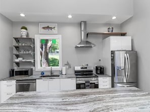 Cook, gather, and enjoy meals in this sleek, modern kitchen! - Hot Tub+Fire Pit, On the River, WiFi, Grill, Cozy! (Burnsville)