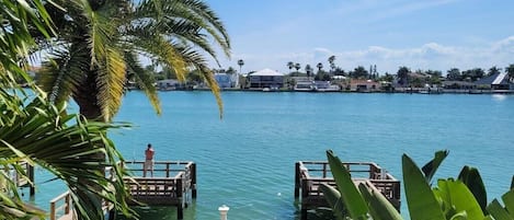 Enjoy waterfront views and a tranquil atmosphere surrounded by lush greenery and palm trees.