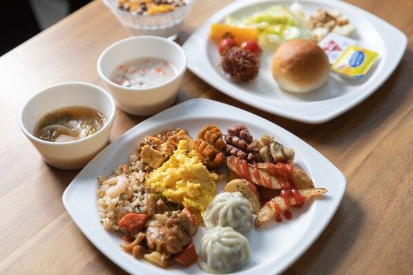 A table with various dishes including rice, eggs, and dumplings. - Withstay Hotel (Jeju City)
