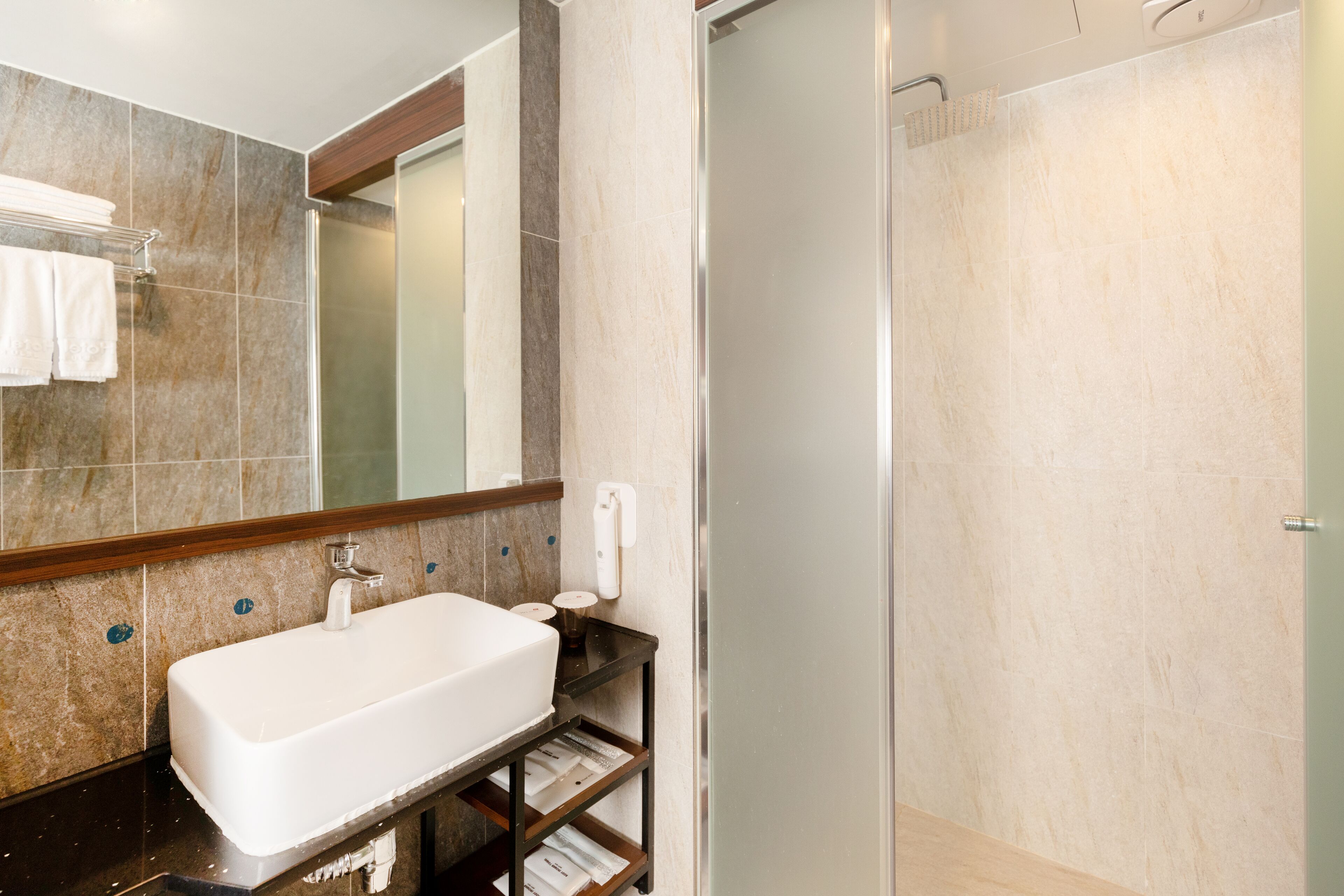 shower, hair dryer, slippers, towels