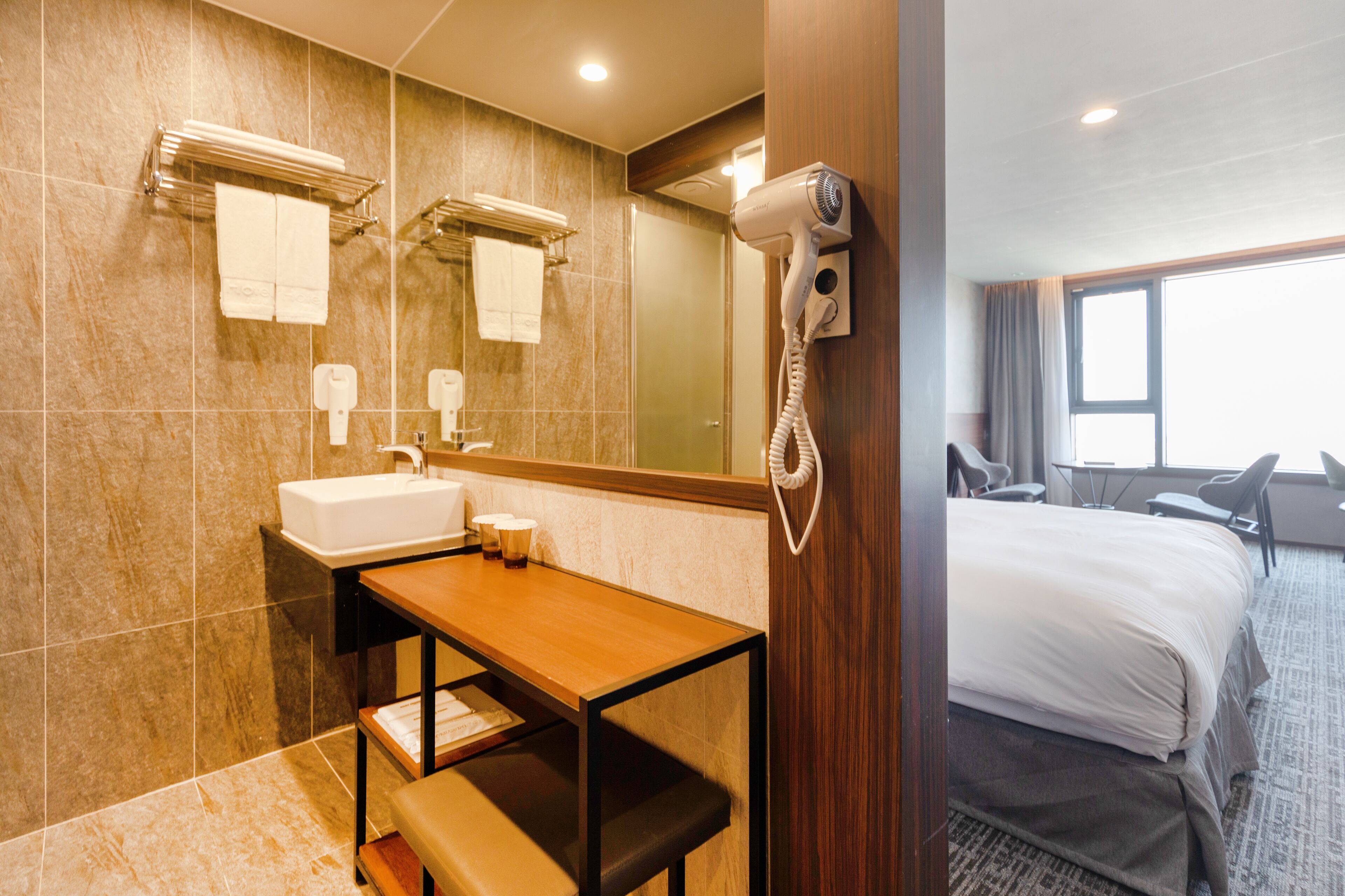 shower, hair dryer, slippers, towels