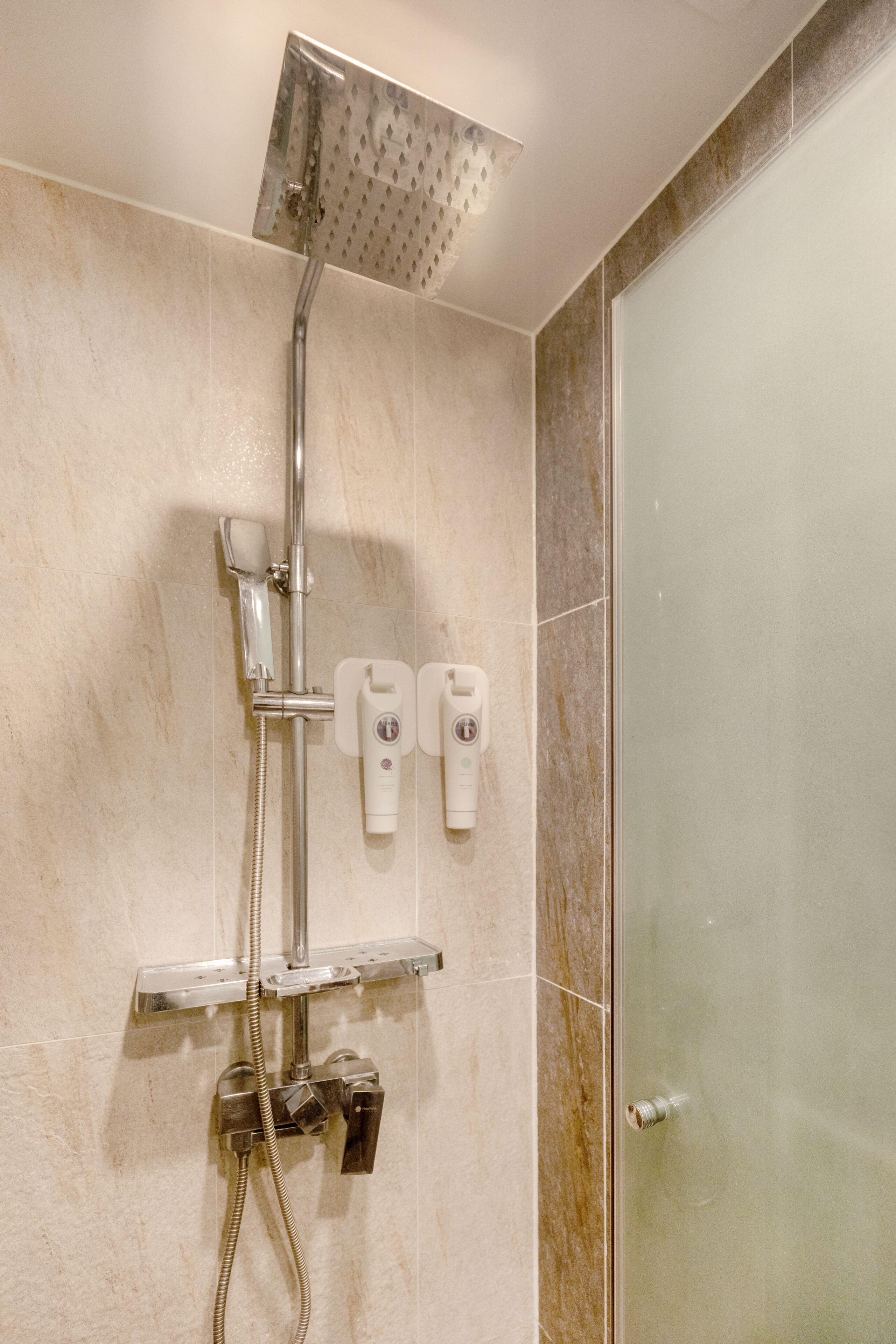 shower, hair dryer, slippers, towels