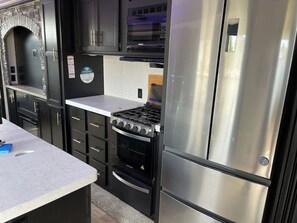 Fridge, microwave, oven, stovetop - Grand Canyon RV Glamping Resort Loft Suite (Williams)