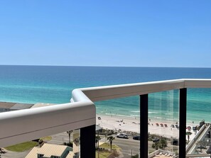 Ein Balkon mit Blick auf Strand und Meer.