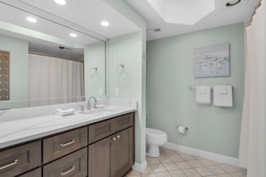 A bathroom with a large mirror, a sink, a toilet, and a shower. - Free Beach SRVC! Gorgeous Ocean & Bay Views! Free Beach Bonfires M/F nts (Miramar Beach)