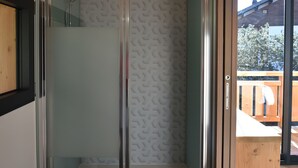 A modern bathroom with a glass shower enclosure, wooden ceiling, and a view of the outdoors. - Chalet for 8 people with Terrace / Garden / Spa - 5 rooms - 4 bedrooms (Montriond)
