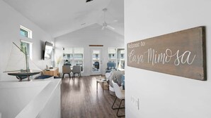 A modern interior with a wooden sign reading "Welcome to Casa MimoSA." - Casa Mimosa: Your Private Beach Escape with Pool, Bikes & Steps to the Sand (Santa Rosa Beach)