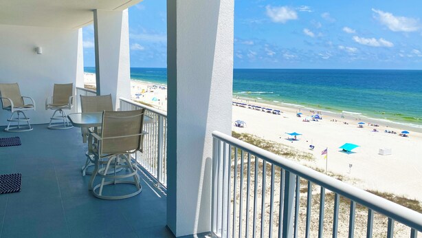 A balcony with a view of a beach and ocean. - Serenity: Island Tower 702 3BR 3BA, 2 Gulf-Front Masters, + Free Beach Service!! (Gulf Shores)
