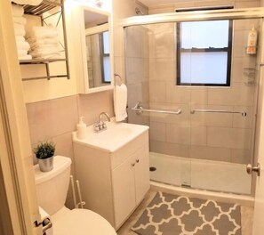 Shower, hair dryer, towels, soap