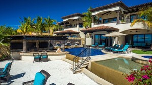 A resort with a swimming pool, outdoor seating, and a view of the ocean. - <br>CHRISTMAS & NEW YEARS EVE  4 BEDROOM LUXURY RESIDENCE AT QUIVIRA LOS CABOS (Cabo San lucas)