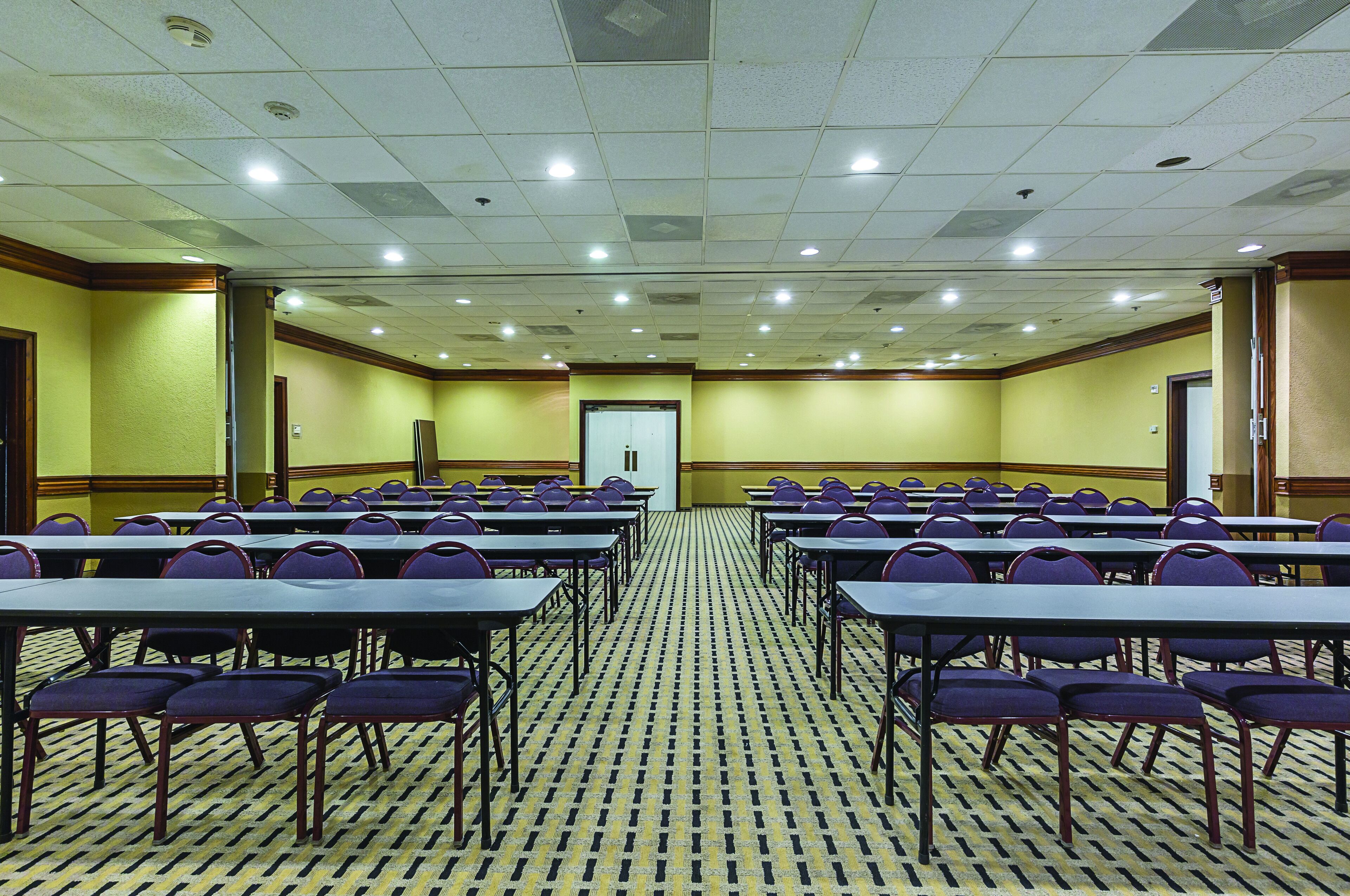 A conference room with tables and chairs arranged for meetings.