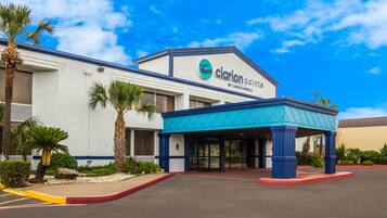Welcome to Clarion Pointe, where a beautiful entrance sets the tone for a relaxing stay amidst lush surroundings.