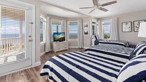 A bedroom with a large bed, a TV, and a ceiling fan. - BEACHFRONT Home with HEATED POOL in North Cape May!!!! (North Cape May)