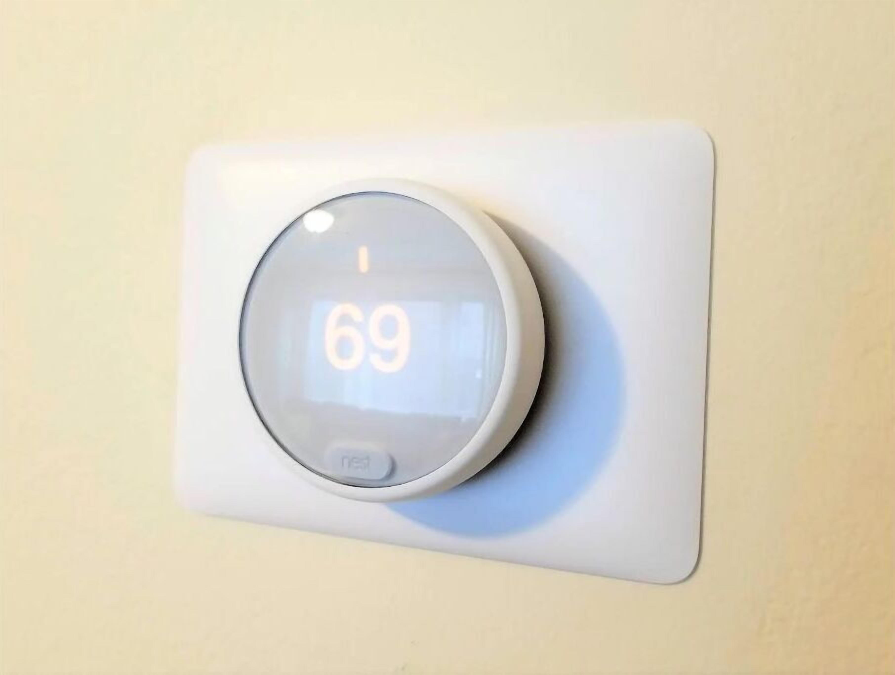 A Nest thermostat mounted on a wall.