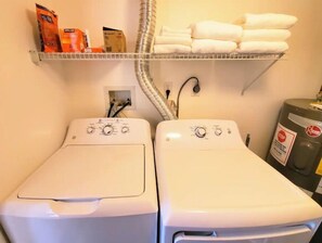 Convenient laundry facilities feature two front-loading washing machines with digital displays.