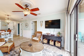 Relax in a spacious living area with a flat-screen TV, dining table, and comfortable seating.