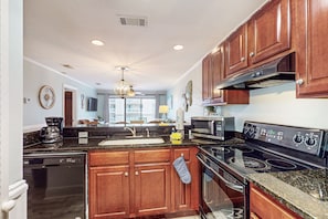 Enjoy cooking in this well-equipped kitchen with a dishwasher, microwave, stove, and oven.