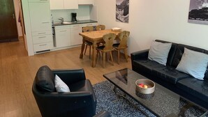 A modern apartment with a kitchen, dining area, and living room. - Erlenrain Wohnung 722E Appartement/Fewo 2-Bettwohnung by Interhome (Engelberg)