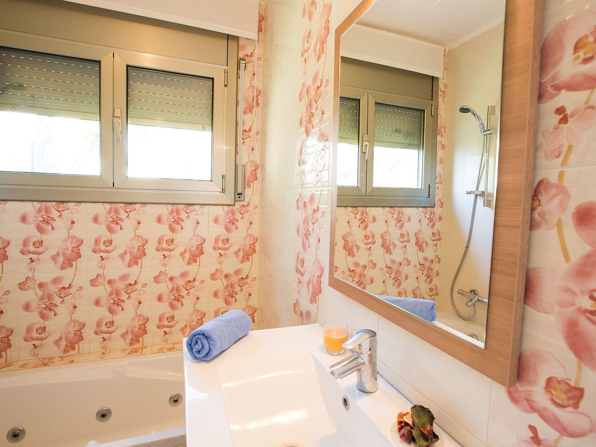 A bathroom with a bathtub, a sink, a mirror, and a shower.