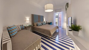 A hotel room with two beds, a large window, a TV, and a potted plant. - Kira Guest House, apt close to Tasso square (Sorrento)