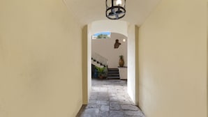 A hallway with stone flooring leading to a staircase. - Kira Guest House, apt close to Tasso square (Sorrento)