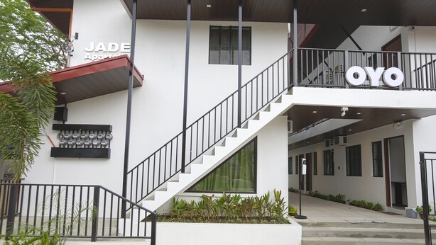 A modern building with a staircase leading to a balcony, labeled "JADE" and "OYO". - OYO 736 Jade Apartelle (Cabuyao)