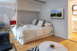 Laptop workspace, iron/ironing board, bed sheets
