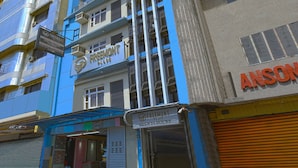 A multi-story building with a blue facade, a sign for 'FREEMONT PLACE' indicating it is a hotel, and another sign for 'ANSON'. - Freemont Place (Parañaque)