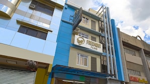 A multi-story building with a sign reading "FREEMONT PLACE" and another sign for "ANSU Shoe Plaza". - Freemont Place (Parañaque)