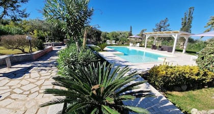 Villa with swimming pool, surrounded by flower gardens, near the sea.