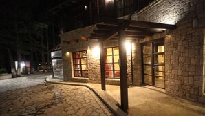 A stone building with a covered entrance and large windows. - Llogora Tourist Village (Orikum)