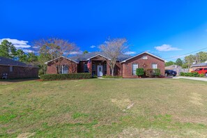 Stunning two-story home with a charming entrance and beautifully manicured lawn.