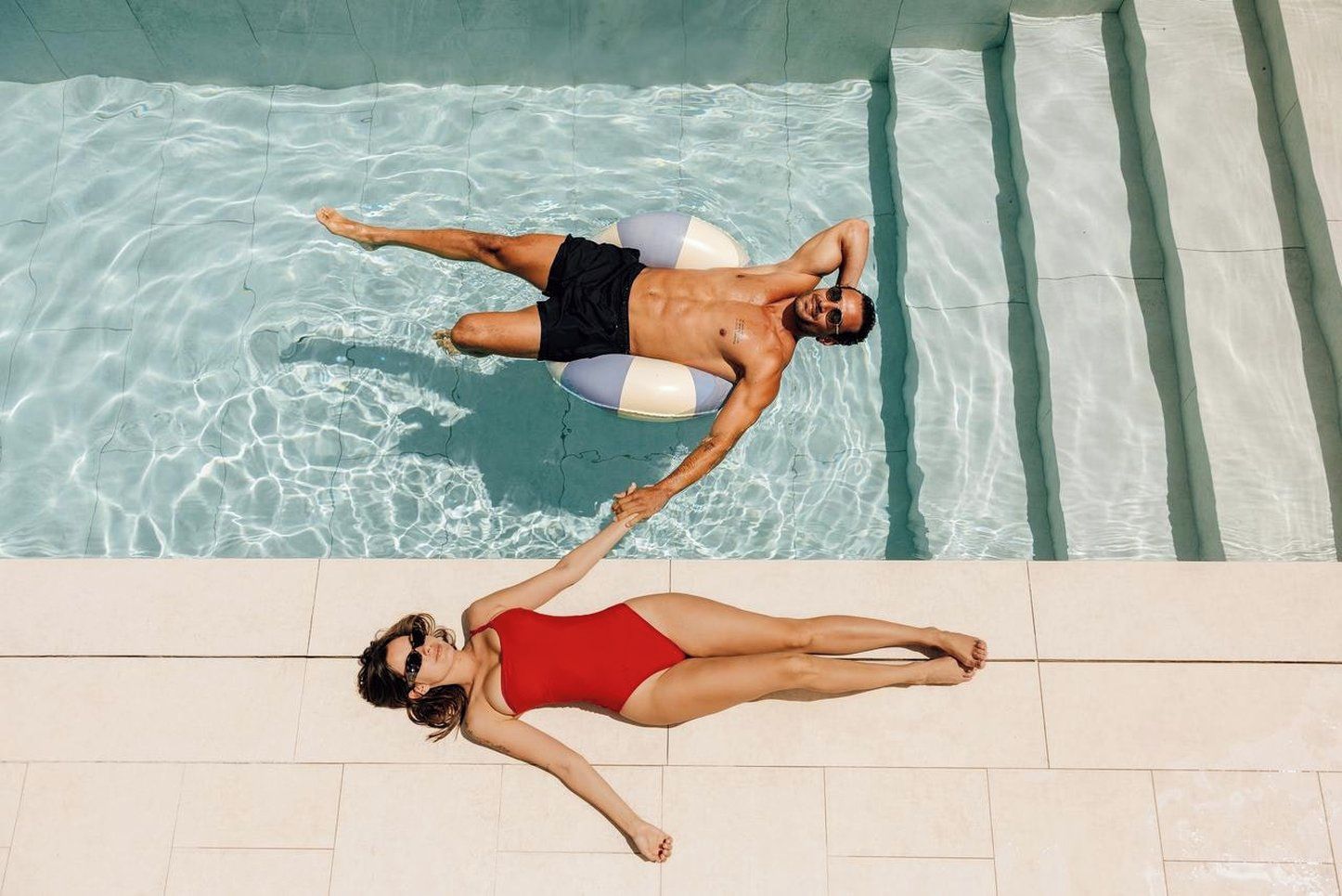A swimming pool with clear water and tiled edges.