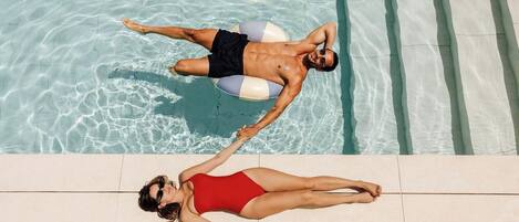A swimming pool with clear water and tiled edges.
