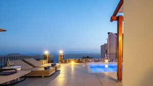 A rooftop pool area with lounge chairs and a view of the sea. - Anastasia Villa, Libyan SeaViews with Heated Pool (Sellia, Rethymno)