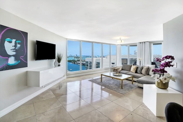Enjoy a city view from the large window, relax on the comfortable sofa, and unwind with a flat-screen TV.