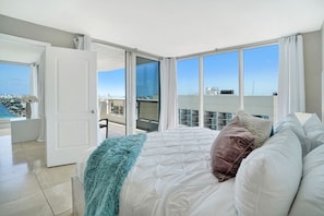 Relax in this stylish room with a large bed, balcony, and city views.