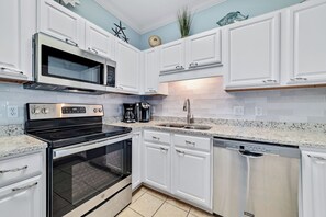 Enjoy cooking in this well-equipped kitchen with a microwave, oven, and dishwasher.