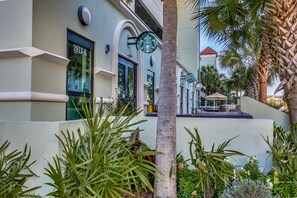 Experience the convenience of a Starbucks coffee shop on site, surrounded by lush tropical plants and a modern, geometric design.