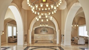 A spacious lobby with a central reception desk, arched ceilings, and a chandelier. - Jaz Makadi Gardens - TUI BLUE Makadi Gardens - Adults Friendly 16 Years Plus (Makadi Bay)