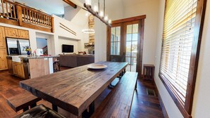 A spacious kitchen with wooden countertops, a large dining table, and a built-in oven. - Snowcreek VI The Lodges 1127 3 Suites, Spacious with Mountain Views, Private Garage and Washer Dryer by RedAwning (Mammoth Lakes)