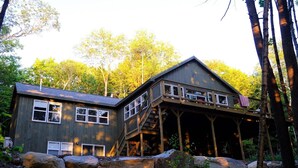 A cabin with a two-story structure, a covered porch, and a steep staircase. - New Waterfront Lake House - completed 2021 (Belgrade)