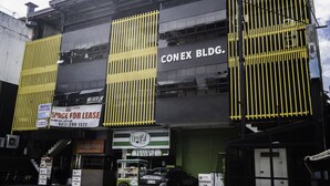 A building with a sign for 'CONEX BLDG.' and a 'NEWLEAF' restaurant. - OYO 711 Goff's Place (Cagayan de Oro)