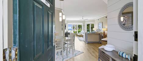 A modern interior with a dining area, kitchen, and living space.
