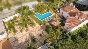 A residential property with a swimming pool, tiled patio, and lush greenery. - Villa Jardin de Mari by Solset (Málaga)